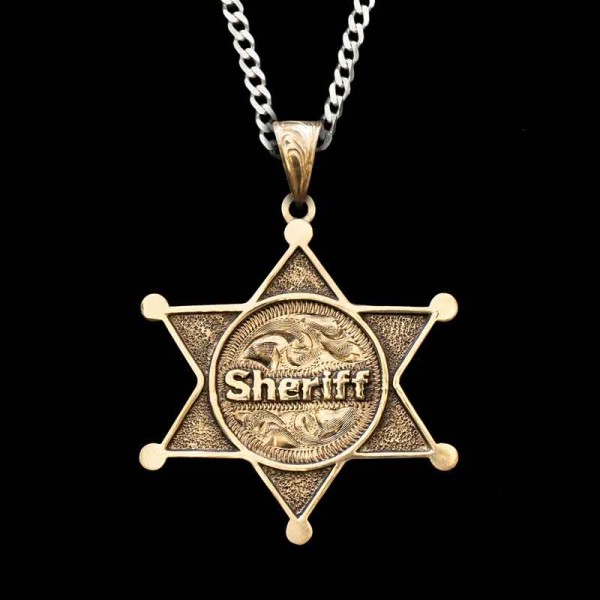Tip your hat to our law enforcement officials with the Sheriff's Badge Custom Pendant. Detailed with our signature antique finish on top our beatiful hand-engraved scrolls. Customize with your lettering and choice of base material by clicking the dropdown